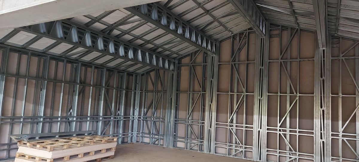 A large steel frame erected inside the extended estate building