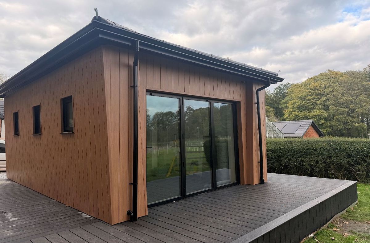 The garden building with sliding glass doors, ready for the sun