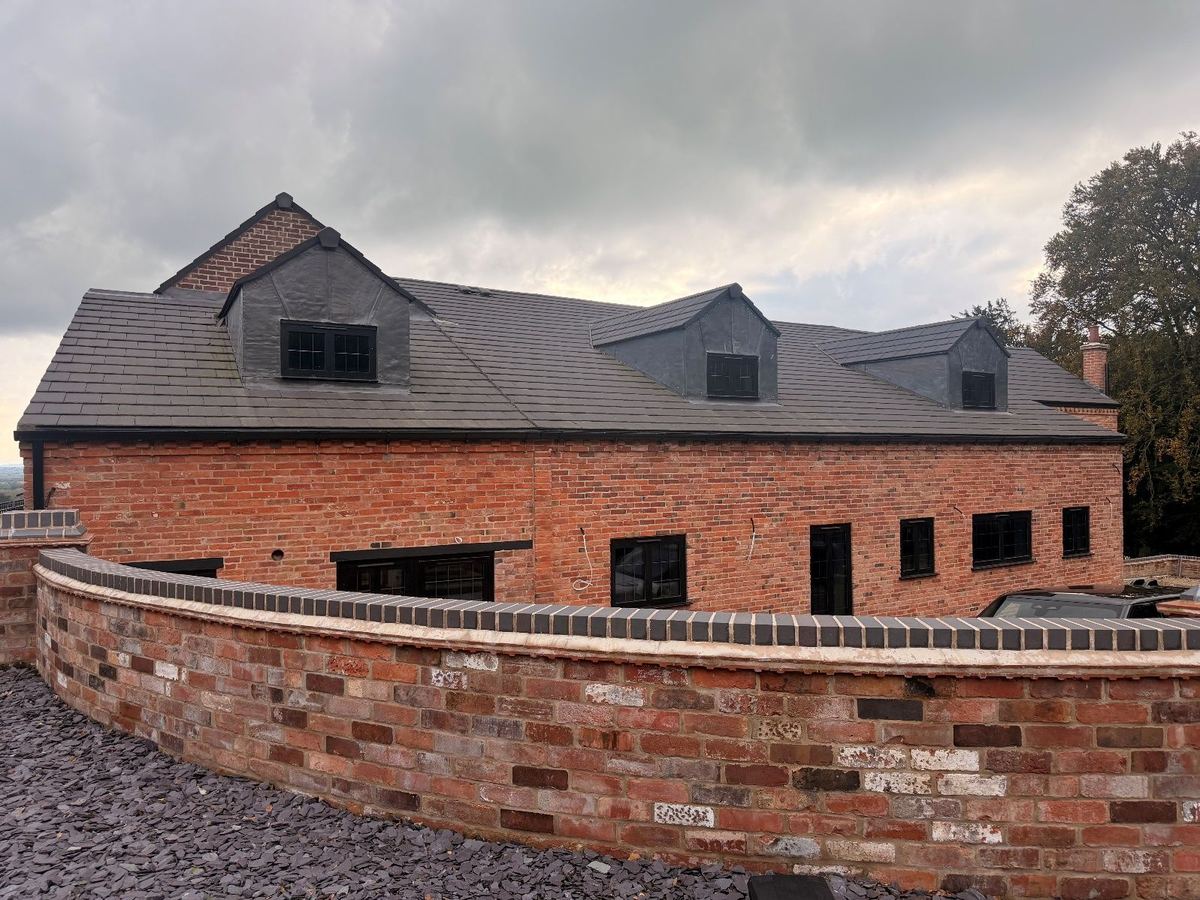 The completed building with a new tiled roof and dormers